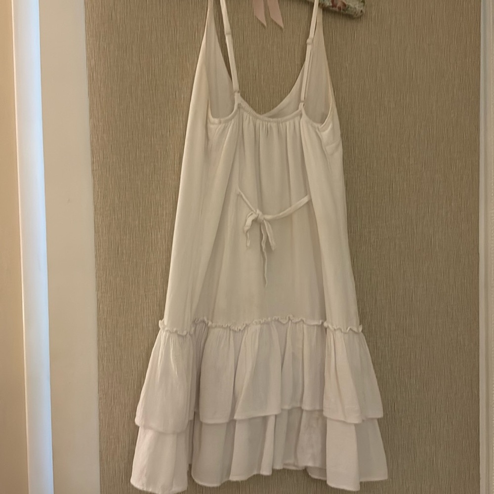 Cute summer dress with back ties. lengths is mor below knee with ruffled hem